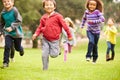 Group Of Young Children Running Towards Camera In Park Royalty Free Stock Photo