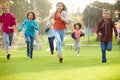 Group Of Young Children Running Towards Camera In Park Royalty Free Stock Photo