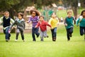 Group Of Young Children Running Towards Camera In Park Royalty Free Stock Photo