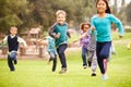 Group Of Young Children Running Towards Camera In Park Royalty Free Stock Photo