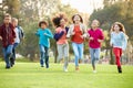 Group Of Young Children Running Towards Camera In Park Royalty Free Stock Photo