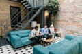 Group of young concentrated international business people discussing a new business project and important ideas, while Royalty Free Stock Photo