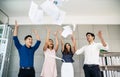 Group of young confident business people happy smile celebrating by throwing their business papers in the air, success team Royalty Free Stock Photo
