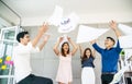 Group of young confident business people happy smile celebrating by throwing their business papers in the air, success team Royalty Free Stock Photo