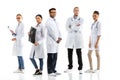 Group of young confident professional doctors in white coats standing