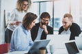 Group of young coworkers brainstorming process at sunny office.Blurred background.