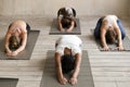 Group of people practicing yoga lesson, doing Child pose, Balasana Royalty Free Stock Photo