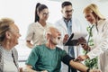 Young doctor during home visit senior people, control blood pressure