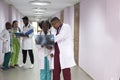 A group of young doctors, mixed race. In the corridor of the hospital, doctors look at X-rays, solving medical problems