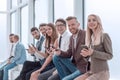 Group of young employees sitting in the office corridor.