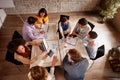 Group of employees working in office, top view