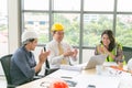 Group of young engineers team giving high five and celebrating success at office. Cheerful startup business team Royalty Free Stock Photo