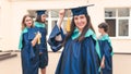 A group of young female graduates. Female graduate is smiling against the background of university graduates Royalty Free Stock Photo