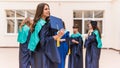 A group of young female graduates. Female graduate is smiling against the background of university graduates Royalty Free Stock Photo