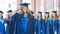 A group of young female graduates. Female graduate is smiling against the background of university graduates Royalty Free Stock Photo