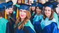 A group of young female graduates. Female graduate is smiling against the background of university graduates Royalty Free Stock Photo