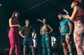 Group of young friends doing sports, training at gym indoors. Cheerful discussion of training class exercises Royalty Free Stock Photo