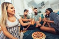 Group of young friends eating pizza.Home party