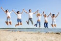 Group young friends enjoying a beach party on vacation. People h Royalty Free Stock Photo