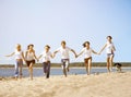 Group young friends enjoying a beach party on vacation. People h