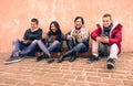 Group of young friends looking their smartphones in old town