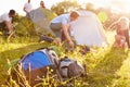 Group Of Young Friends Pitching Tents On Camping Holiday