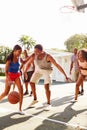 Group Of Young Friends Playing Basketball Match