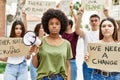 Group of young friends protesting and giving slogans at the street thinking attitude and sober expression looking self confident Royalty Free Stock Photo