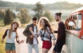 A group of young friends on a roadtrip through countryside, dancing. Royalty Free Stock Photo