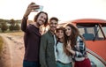 A group of young friends on a roadtrip through countryside, taking selfie. Royalty Free Stock Photo