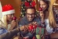 Friends having fun while exchanging Christmas presents Royalty Free Stock Photo