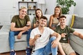 Group of young friends smiling happy drinking red wine at home Royalty Free Stock Photo