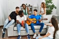 Group of young friends smiling happy and playing classical guitar at home Royalty Free Stock Photo