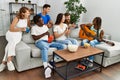 Group of young friends smiling happy and playing classical guitar at home Royalty Free Stock Photo