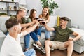 Group of young friends smiling happy toasting with glass of red wine at home Royalty Free Stock Photo