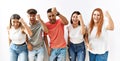 Group of young friends standing together over isolated background angry and mad raising fist frustrated and furious while shouting Royalty Free Stock Photo