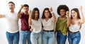 Group of young friends standing together over isolated background angry and mad raising fist frustrated and furious while shouting Royalty Free Stock Photo