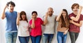 Group of young friends standing together over isolated background angry and mad raising fist frustrated and furious while shouting Royalty Free Stock Photo
