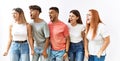 Group of young friends standing together over isolated background angry and mad screaming frustrated and furious, shouting with Royalty Free Stock Photo