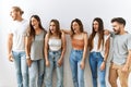 Group of young friends standing together over isolated background angry and mad screaming frustrated and furious, shouting with Royalty Free Stock Photo