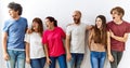 Group of young friends standing together over isolated background angry and mad screaming frustrated and furious, shouting with Royalty Free Stock Photo