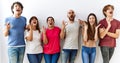 Group of young friends standing together over isolated background crazy and mad shouting and yelling with aggressive expression Royalty Free Stock Photo