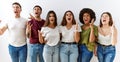 Group of young friends standing together over isolated background crazy and mad shouting and yelling with aggressive expression Royalty Free Stock Photo