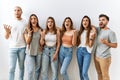 Group of young friends standing together over isolated background crazy and mad shouting and yelling with aggressive expression Royalty Free Stock Photo