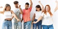 Group of young friends standing together over isolated background dancing happy and cheerful, smiling moving casual and confident Royalty Free Stock Photo