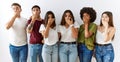 Group of young friends standing together over isolated background shocked covering mouth with hands for mistake Royalty Free Stock Photo