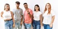 Group of young friends standing together over isolated background showing and pointing up with fingers number three while smiling Royalty Free Stock Photo