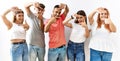 Group of young friends standing together over isolated background smiling making frame with hands and fingers with happy face Royalty Free Stock Photo