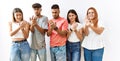 Group of young friends standing together over isolated background suffering pain on hands and fingers, arthritis inflammation
