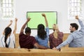 Group Of Young Friends Watching Sports On Television And Cheering Royalty Free Stock Photo
